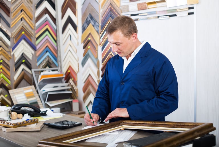 Kent Studios craftsman providing expert framing consultation